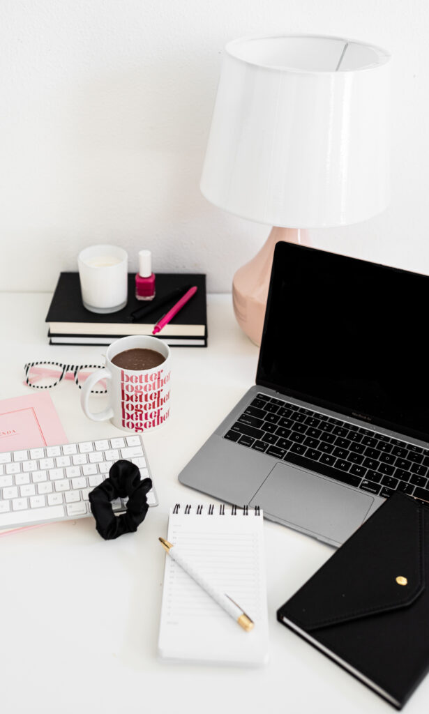 Organized desk with laptop, coffee, and stationery, perfect for planning sessions. Simplify your setup because Aisle Planner can do it all!